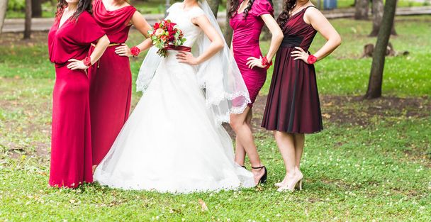Bride with bridesmaids outdoors on the wedding day - Photo, Image