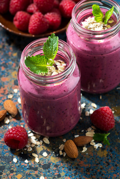 berry smoothie in a bottle on a dark background, vertical - Photo, Image