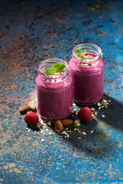 healthy berry smoothie in a bottle and dark background, vertical - Φωτογραφία, εικόνα