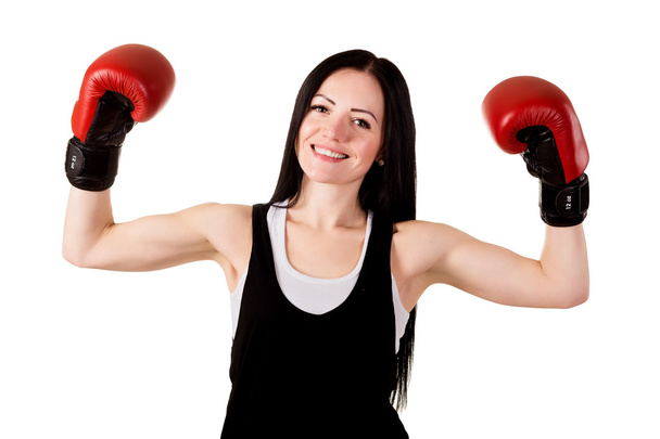 Smiling brunette girl with long hair in red boxing gloves raised - Foto, Imagen