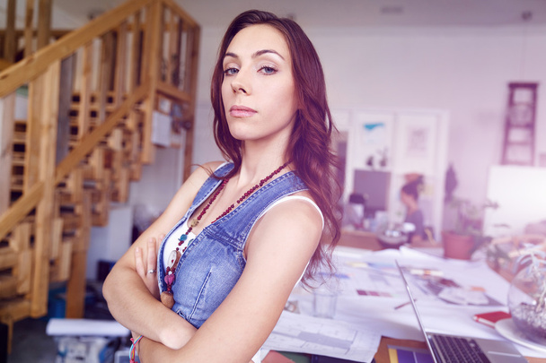 Young woman standing in creative office - Foto, imagen
