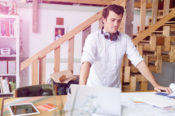 Young man standing in creative office - Photo, Image