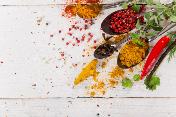 Various colorful spices on wooden table - Fotoğraf, Görsel