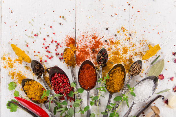 Various colorful spices on wooden table - 写真・画像