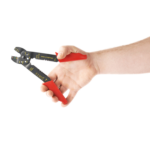 Hand holding a wire stripper tool, composition isolated over the white background - Photo, image