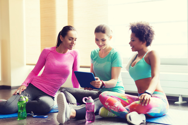 group of happy women with tablet pc in gym - Фото, зображення