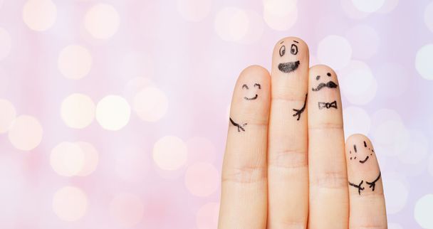 close up of four fingers with smiley faces - Фото, изображение