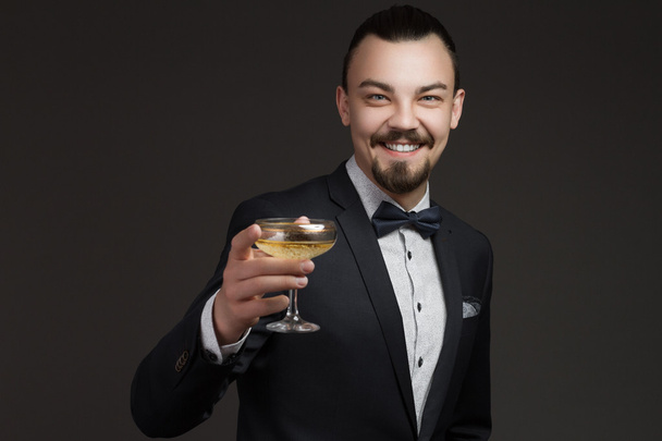 Fashionable young man with a glass of champagne - Φωτογραφία, εικόνα