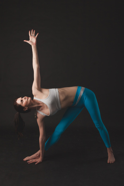 Beautiful sporty yogi girl practices yoga asana - Fotó, kép