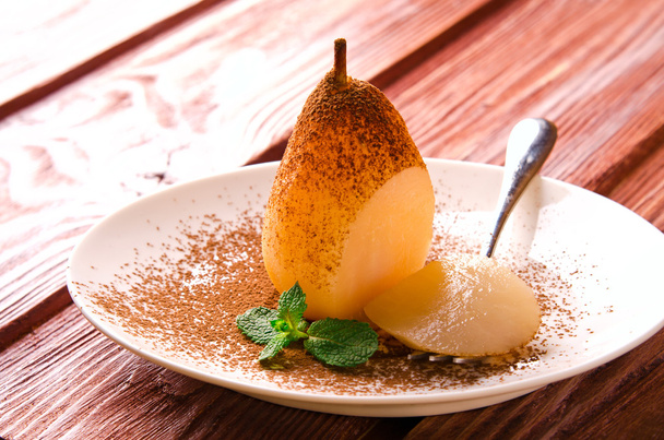 Poached pears with cocoa and mint on white plate - Fotoğraf, Görsel