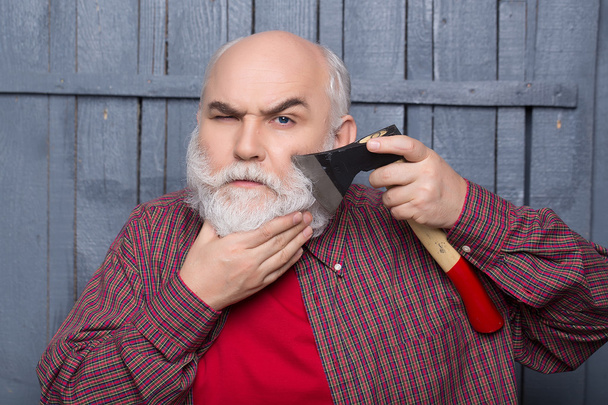 Old man shaving with axe - Foto, Bild
