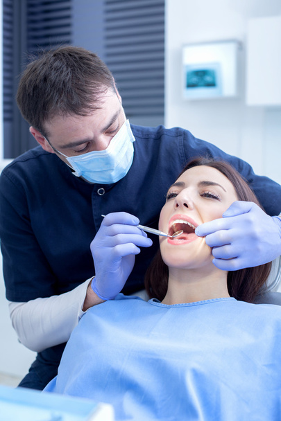 Male dentist in action - Photo, image