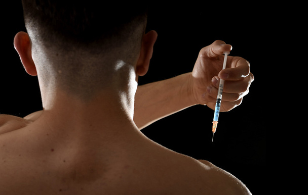 young body building sportsman using steroids for increasing sport and athletic  performance injecting syringe shoulder - Photo, image