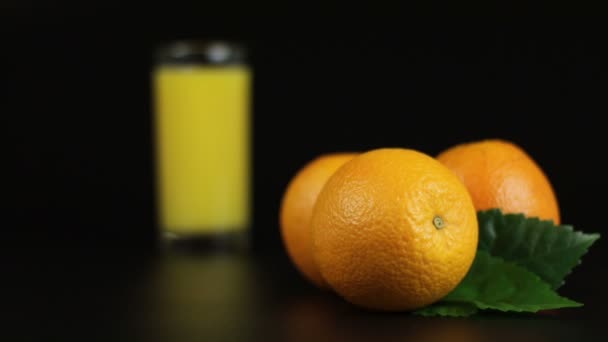 Refocusing with orange juice in a glass - Footage, Video