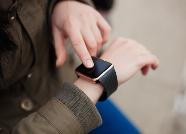 Hands of a girl using her smart watch - Photo, Image