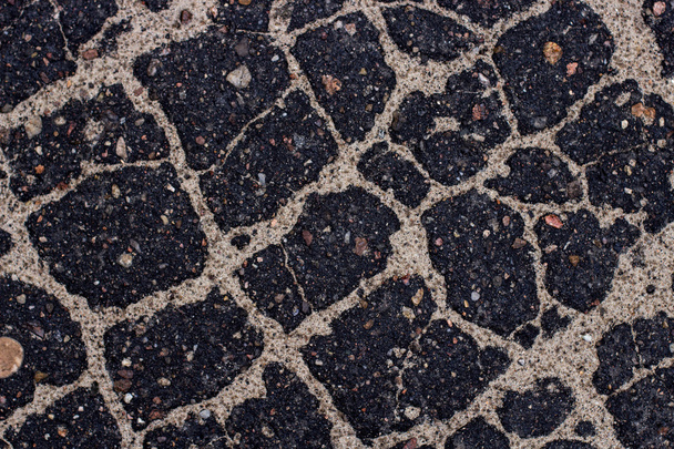 Old asphalt with stones. - Zdjęcie, obraz