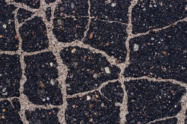 Old asphalt with stones. - Zdjęcie, obraz