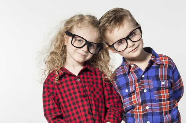 Funny lovely children.  fashionable little boy and girl in glasses, jeans, white t-shirts and plaid shirts.stylish kids in casual shoes. fashion children - Foto, afbeelding