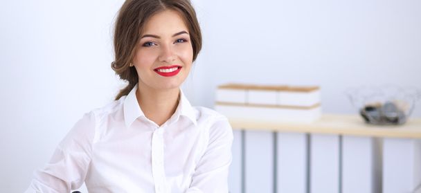 Attractive businesswoman sitting  in the office - 写真・画像