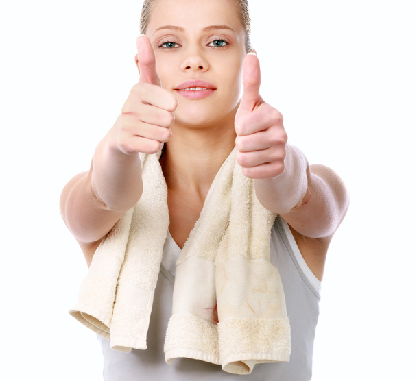 Young sportive girl with towel showing ok, isolated on white background - Photo, image