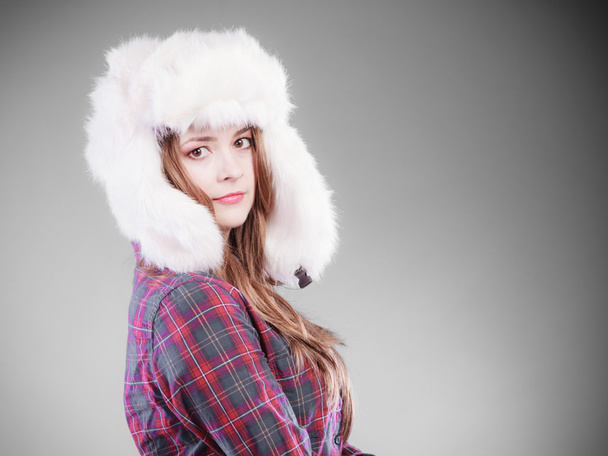 Young woman in winter clothing fur cap - 写真・画像