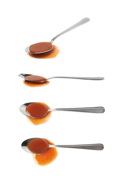 Steel spoon in a puddle of hot sauce - Foto, Imagem