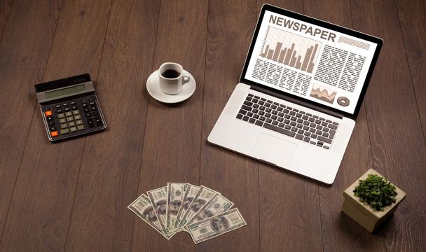 Business laptop with stock market report on wooden desk - Fotografie, Obrázek