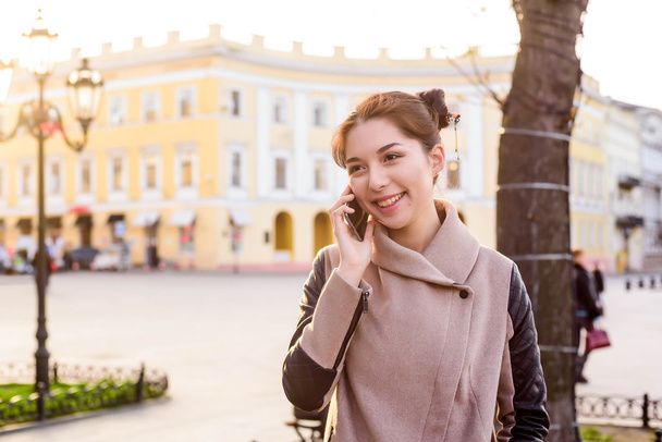 beautiful asian female speaking on phone on the street. Woman in - Photo, image