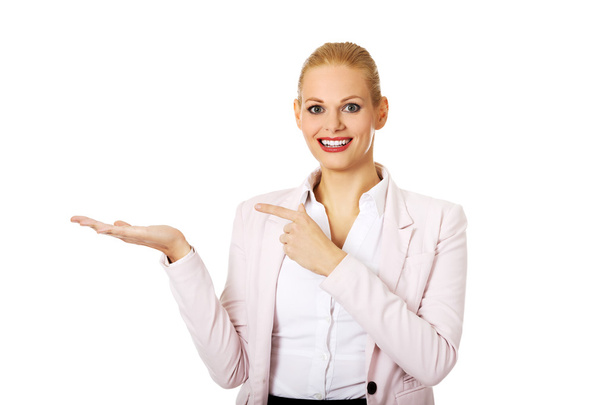 Business woman presenting something on open palm - Photo, Image