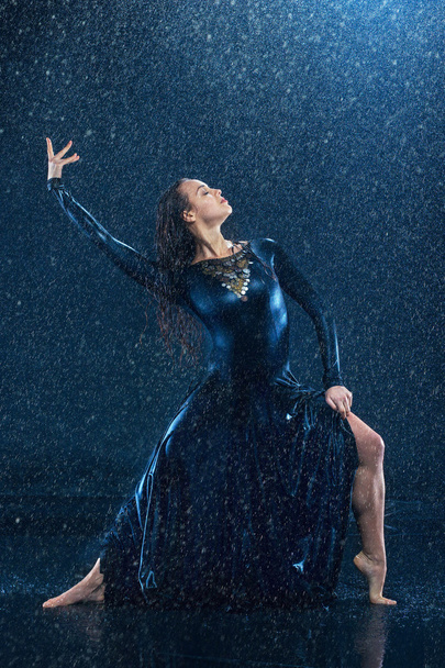 The young beautiful modern dancer dancing under water drops - 写真・画像