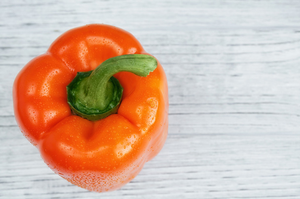 Orange paprika (pepper) on a white wooden background - Foto, immagini