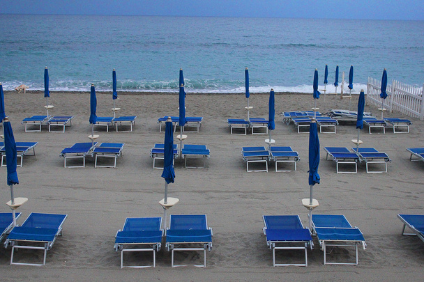 deck chairs and umbrellas in front of the sea - Photo, Image