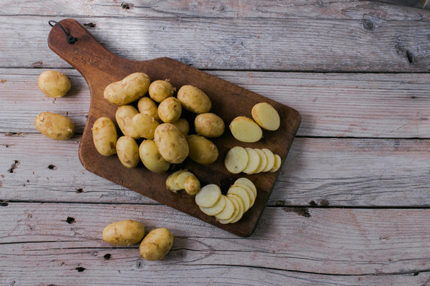 Fresh organic potatoes on a wooden table - Photo, Image
