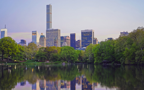 Midtown Manhattan skyline reflected from water of Central Park - Photo, Image