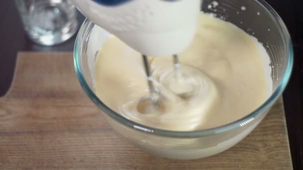 Mixing dough in bowl with motor mixer. Baking ingredients. Baking cake - Кадры, видео