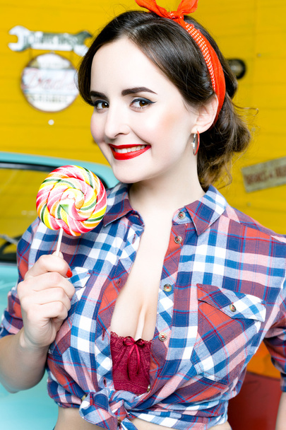 Woman With Pinup Style holding lollipop - Фото, зображення
