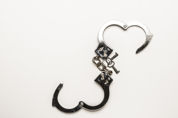 Silver handcuffs with heart shape - Φωτογραφία, εικόνα