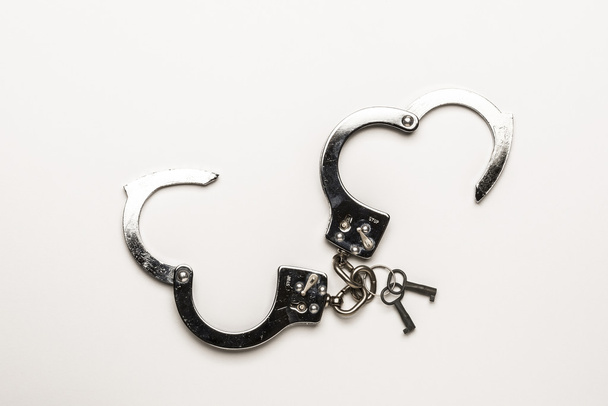 Silver handcuffs with heart shape - 写真・画像