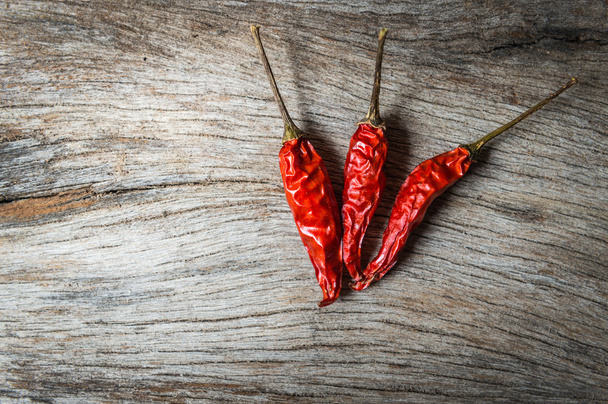 red chilli on wooden background - 写真・画像