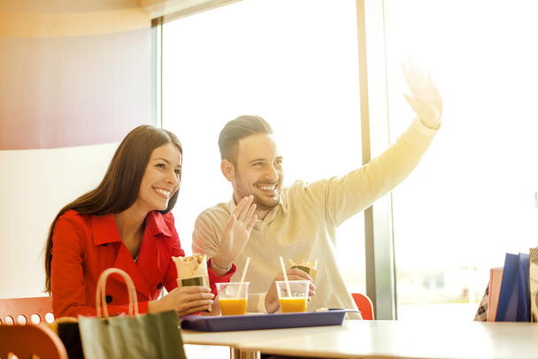 Couple having fun in fast food restaurant - Photo, Image