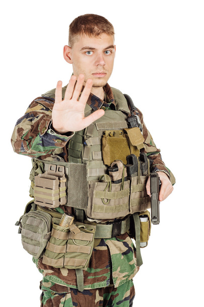 Military, profession, people and war concept - male soldier in camouflage posing against a white wall - Foto, Imagen