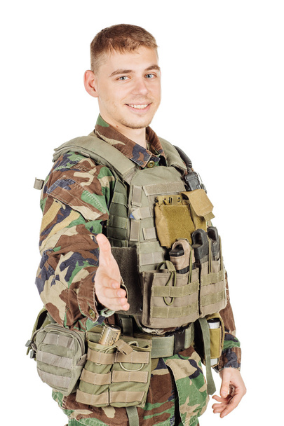 Military, profession, people and war concept - male soldier in camouflage posing against a white wall - Foto, imagen
