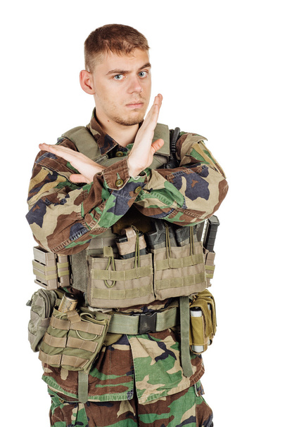 Military, profession, people and war concept - male soldier in camouflage posing against a white wall - Fotó, kép