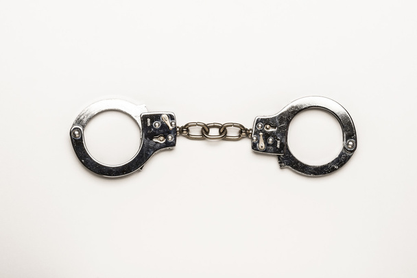 Silver handcuffs on white background - Φωτογραφία, εικόνα