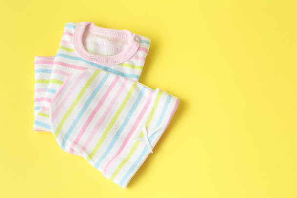 Baby clothing on a yellow background - Photo, image
