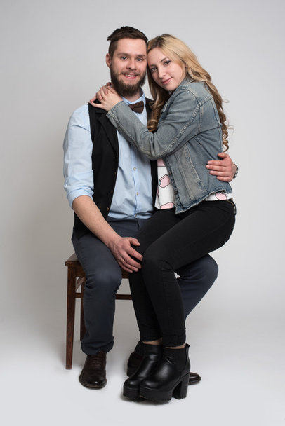 young man and woman sitting on a chair  - Fotó, kép