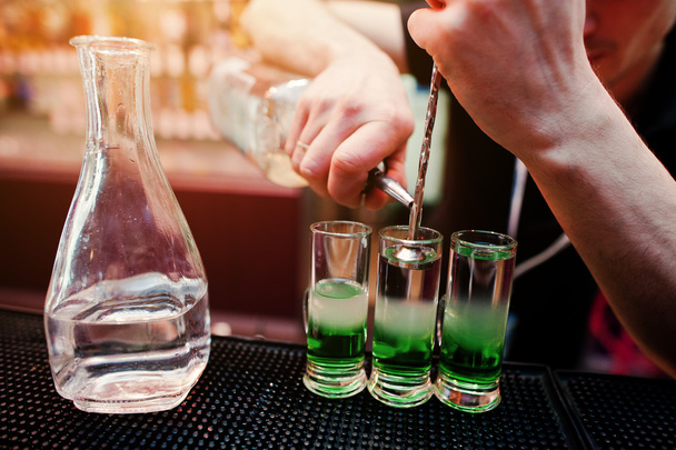Close up barman hands  preparing green mexican cocktail drink at - 写真・画像