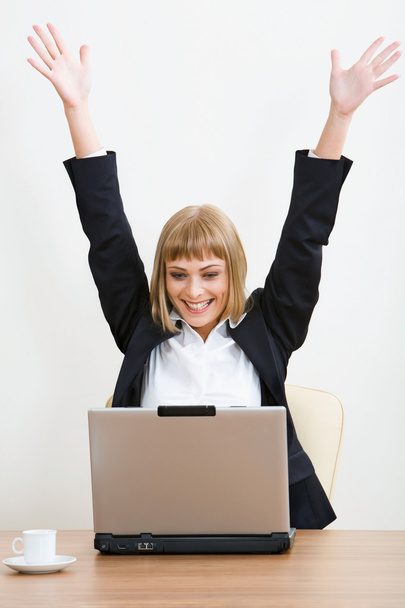 Portrait of smiling businesswoman with raised hands - Foto, Bild