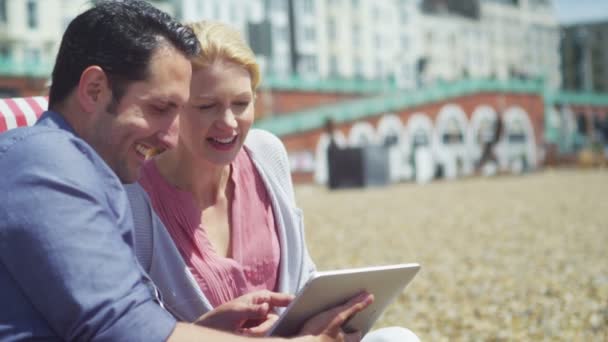 Couple with computer tablet laughing - Felvétel, videó