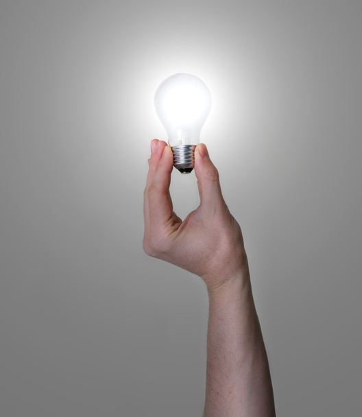 Hand holding glowing light bulb - Photo, Image